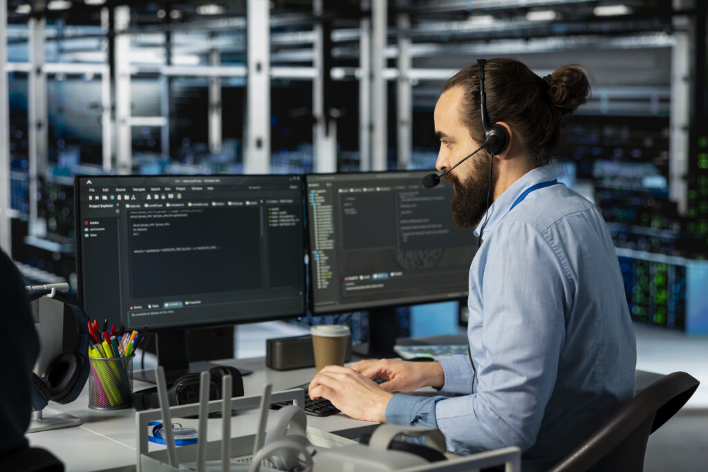 man doing tech support in server room, managing large scale it infrastructure